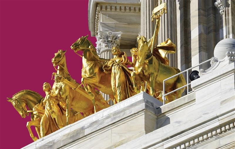 close-up shot of the gold horses statue atop the Minnesota State Capitol building